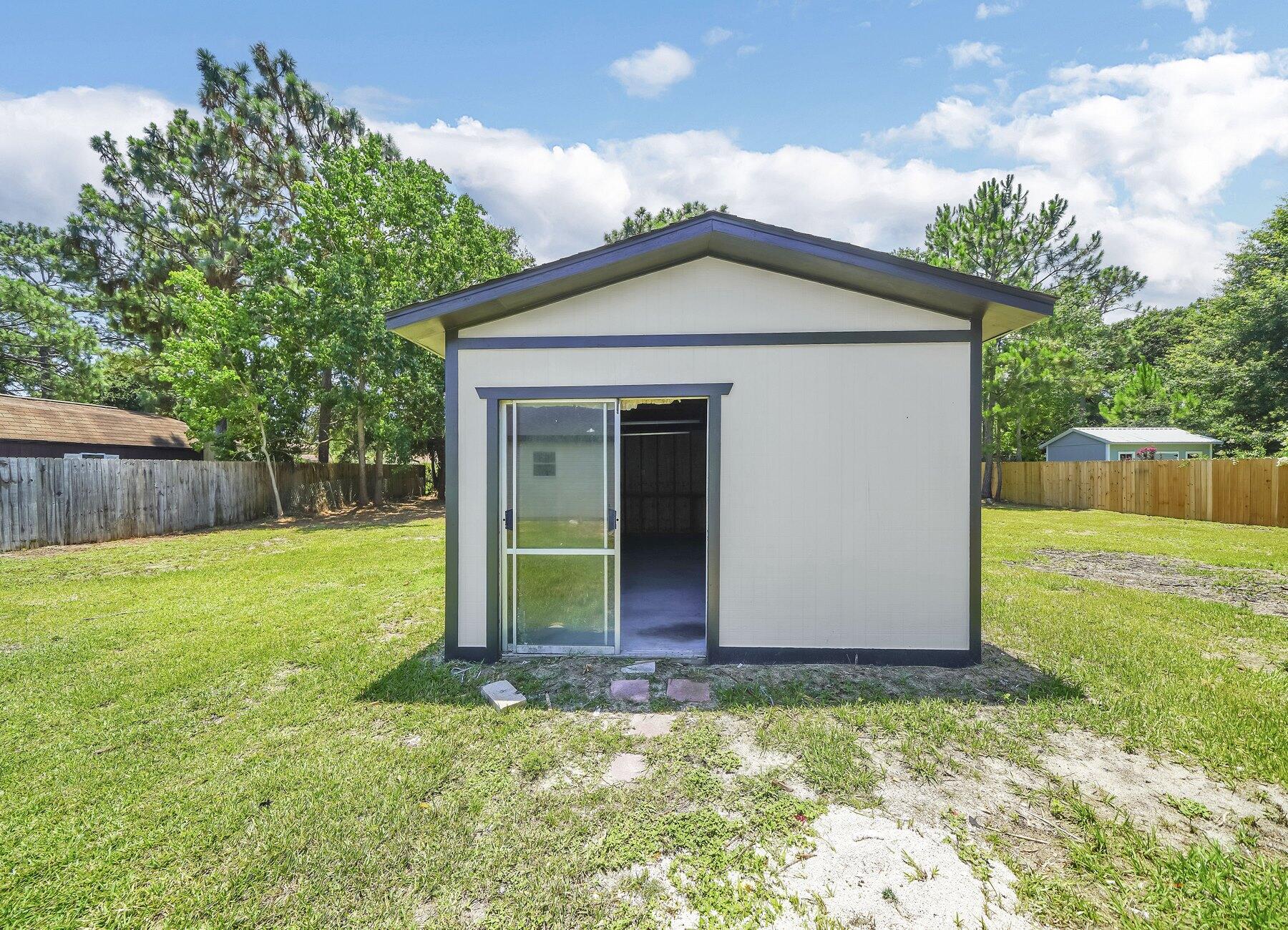 6935 Jasper Street Navarre, FL 32566 - Photo 35 of 45 a view of a house with a yard
