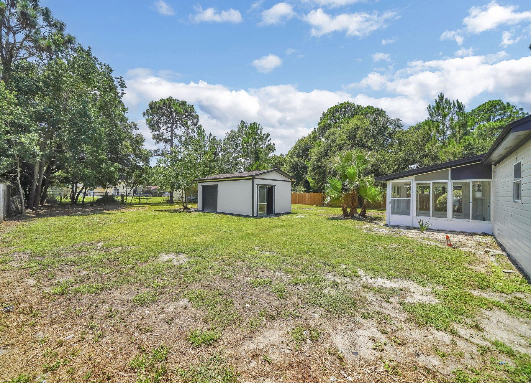 6935 Jasper Street Navarre, FL 32566 - Photo 37 of 45 a front view of house with yard and green space