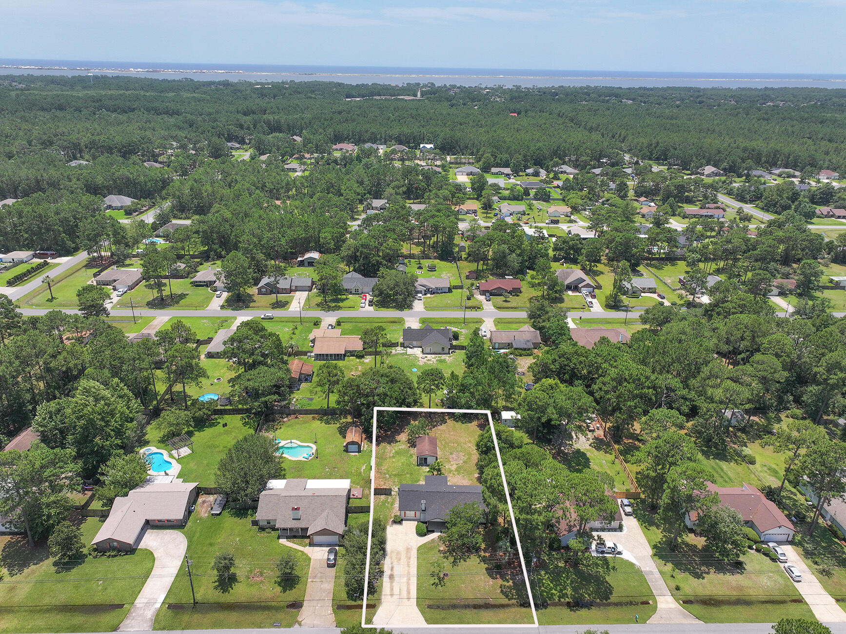 6935 Jasper Street Navarre, FL 32566 - Photo 5 of 45 an aerial view of residential houses with outdoor space and trees