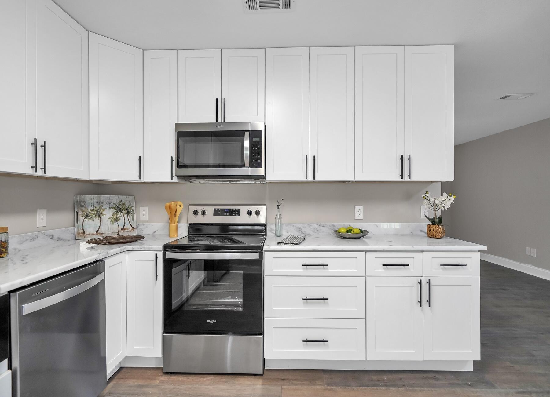 6935 Jasper Street Navarre, FL 32566 - Photo 7 of 45 a kitchen with white cabinets and appliances