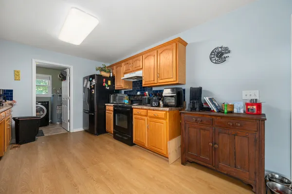 a kitchen with stainless steel appliances granite countertop a refrigerator and a stove top oven