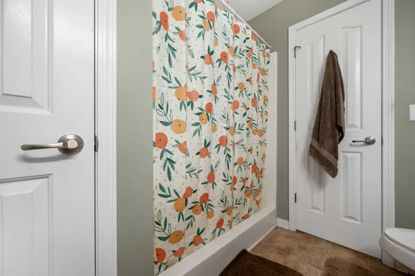 a view of bathroom with a shower and a shower curtain