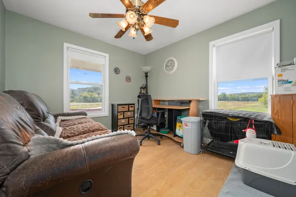a bedroom with furniture and a flat screen tv