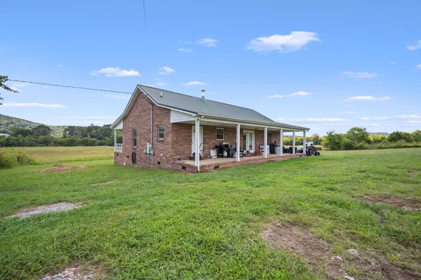 a view of a house with backyard porch and garden
