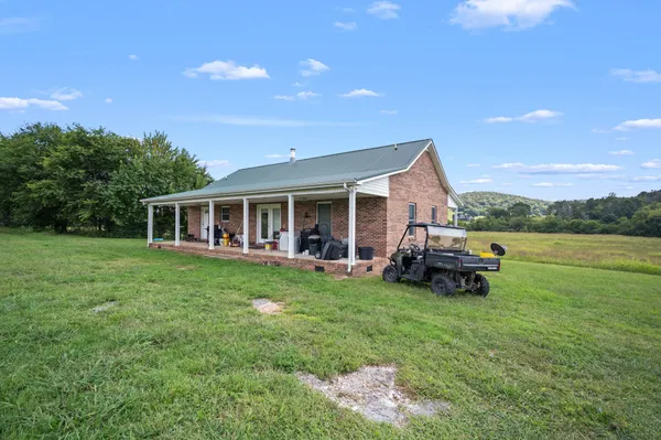 a view of a house with a yard porch and sitting area