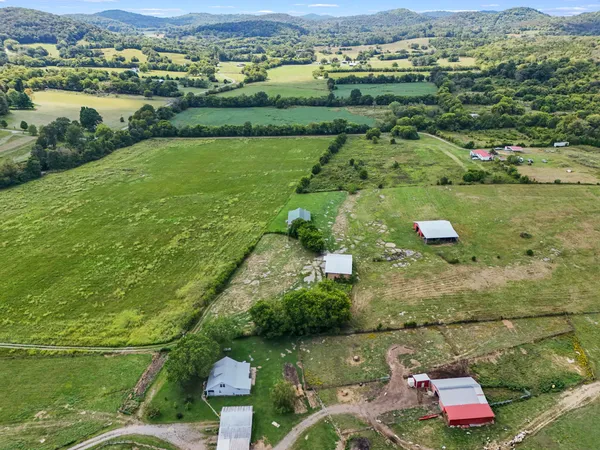 an aerial view of residential houses with outdoor space and river