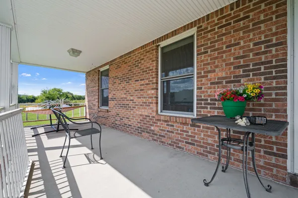 a view of a chairs and table in a patio