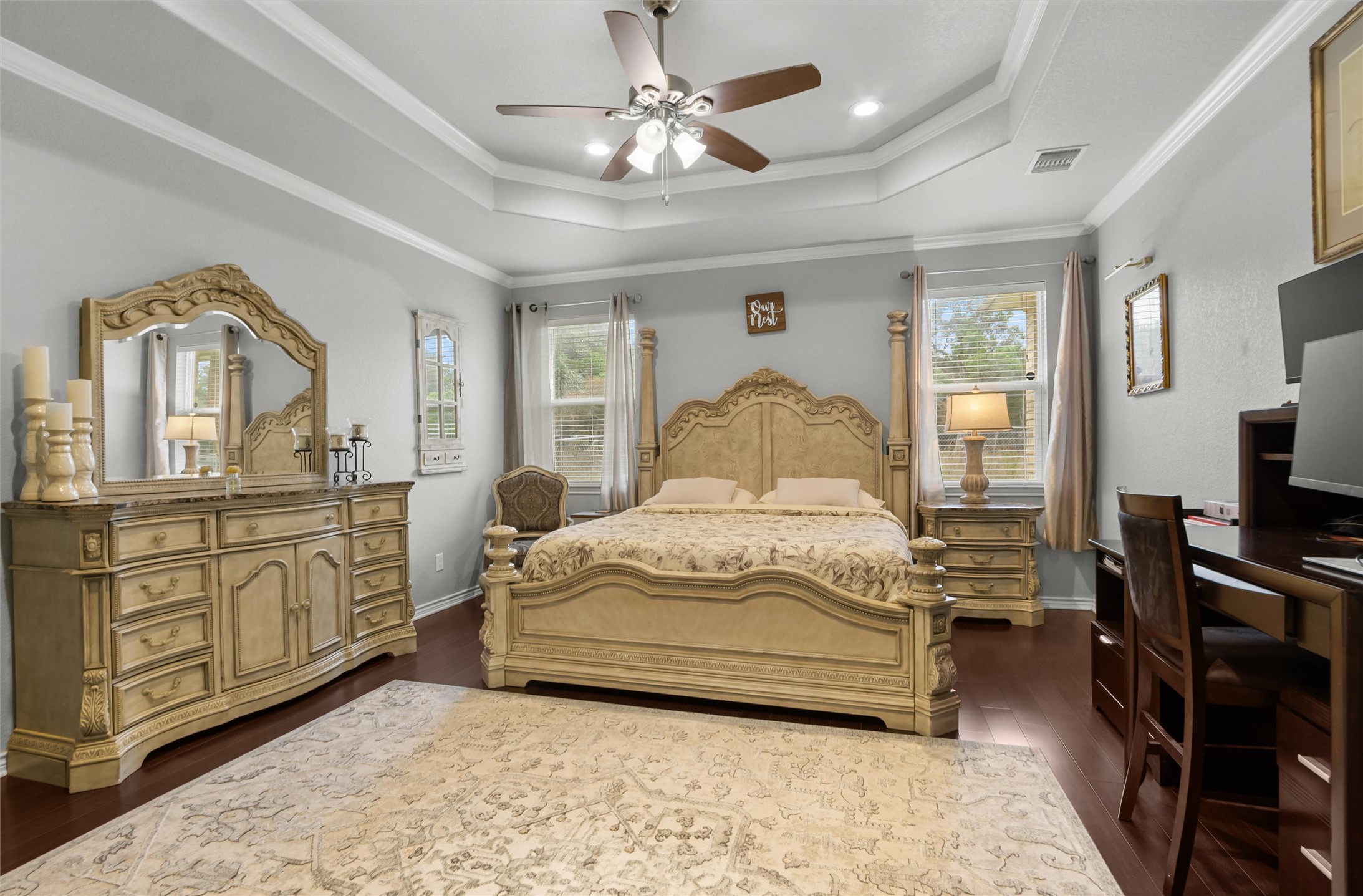 16017 Toby Court Temple, TX 76502 - Photo 12 of 33 Bedroom featuring crown molding, dark wood-style flooring, a ceiling fan, multiple windows, and a tray ceiling