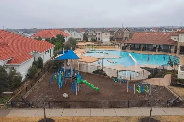 an aerial view of a house with garden space and outdoor seating
