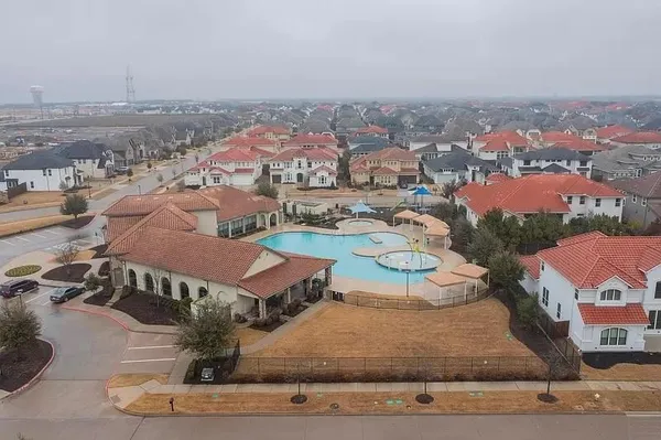 an aerial view of residential houses with outdoor space
