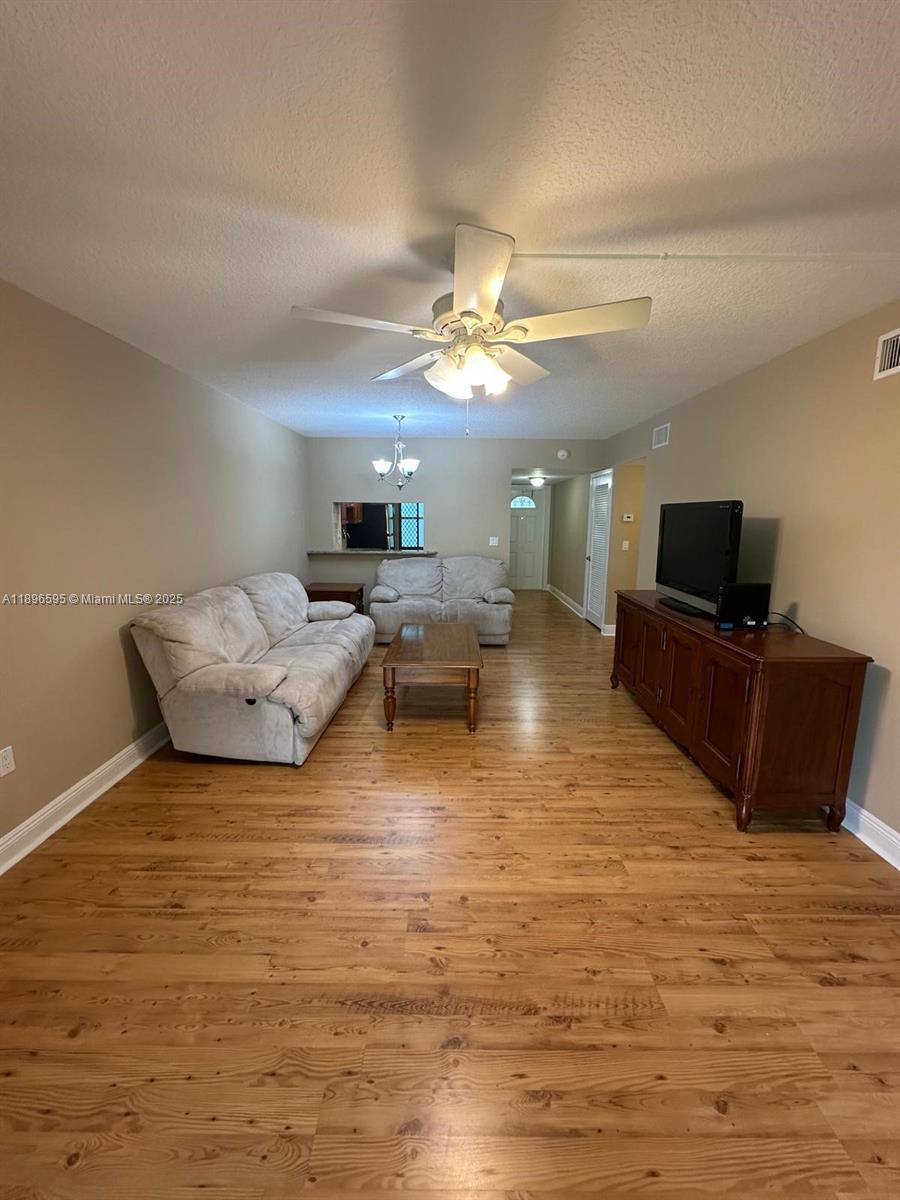 9848 Marina Boulevard, Unit 811 Boca Raton, FL 33428 - Photo 21 of 87 a living room with furniture and a flat screen tv