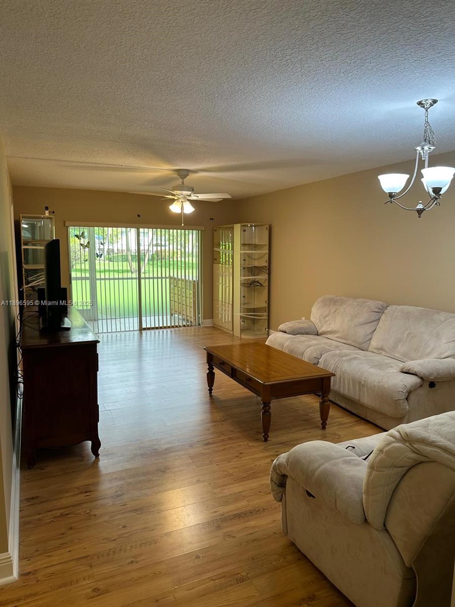 9848 Marina Boulevard, Unit 811 Boca Raton, FL 33428 - Photo 22 of 87 a living room with furniture wooden floor and floor to ceiling window