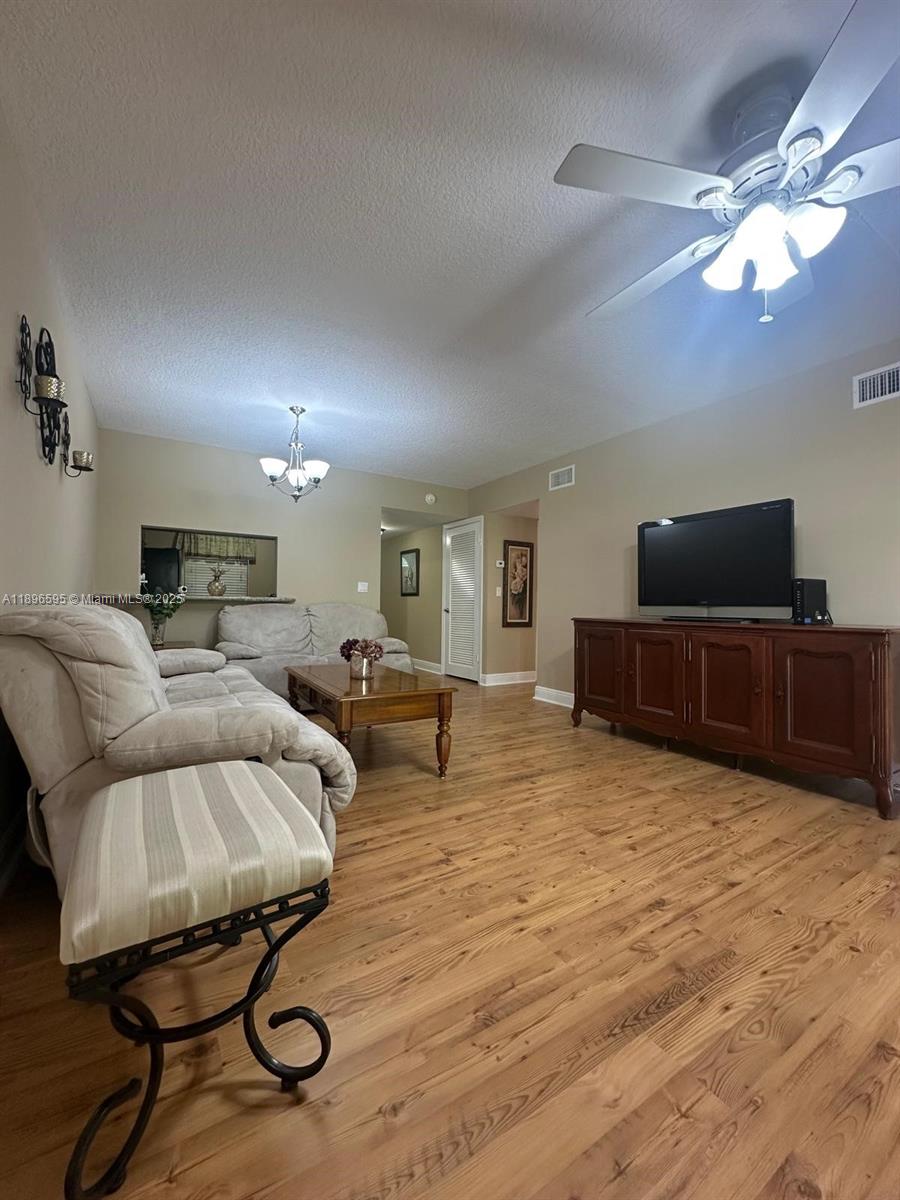 9848 Marina Boulevard, Unit 811 Boca Raton, FL 33428 - Photo 24 of 87 a living room with furniture and a flat screen tv