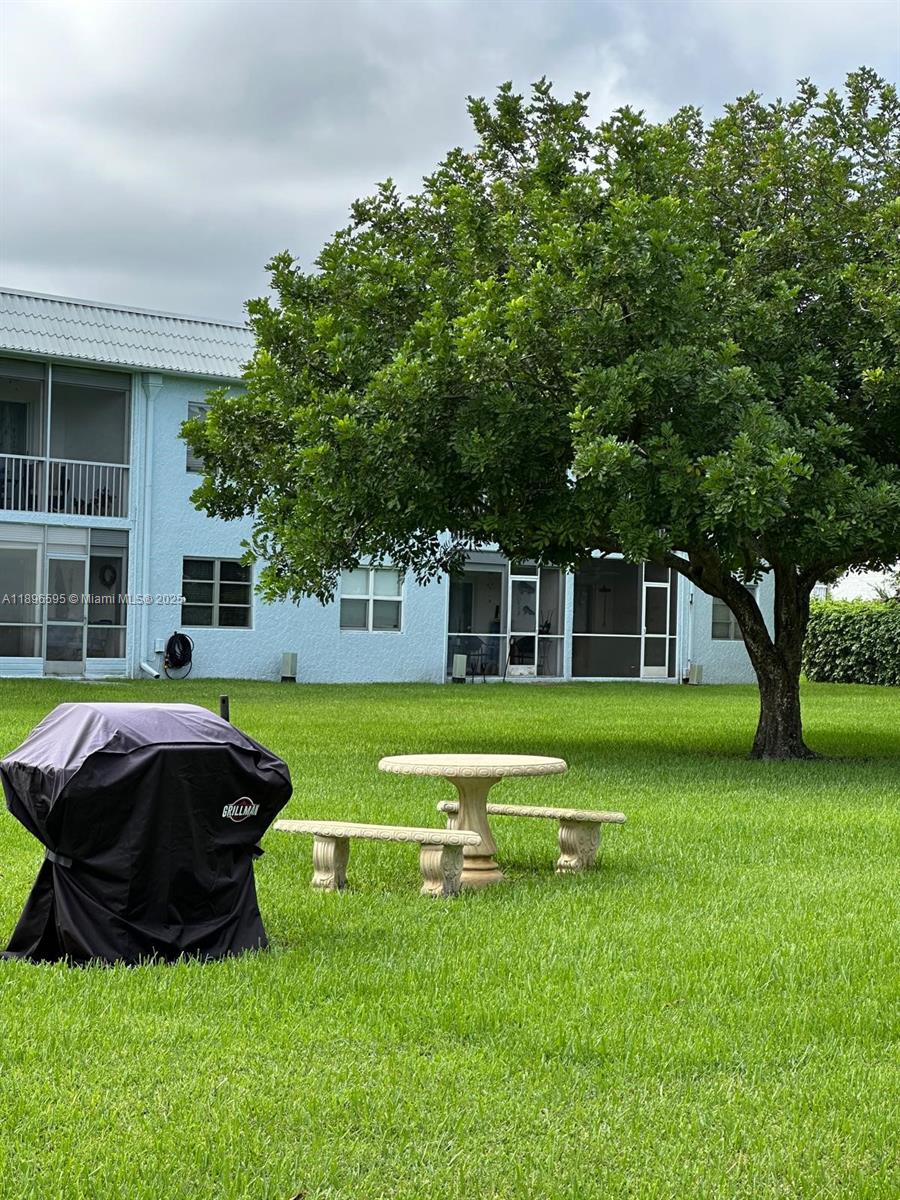 9848 Marina Boulevard, Unit 811 Boca Raton, FL 33428 - Photo 34 of 87 a front view of a house with a garden