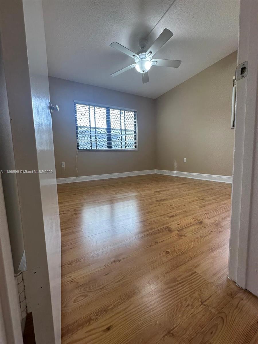 9848 Marina Boulevard, Unit 811 Boca Raton, FL 33428 - Photo 37 of 87 an empty room with wooden floor and windows