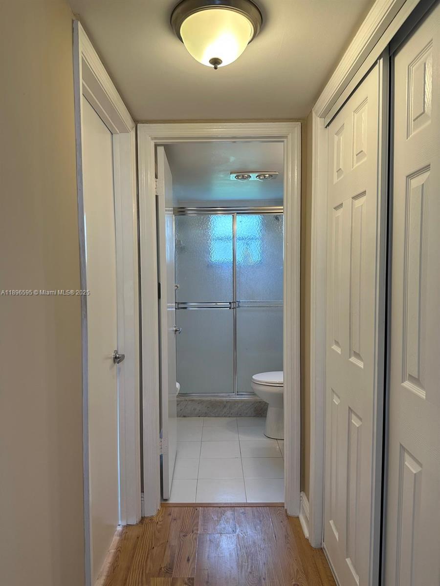 9848 Marina Boulevard, Unit 811 Boca Raton, FL 33428 - Photo 45 of 87 a bathroom with a glass shower door and a toilet