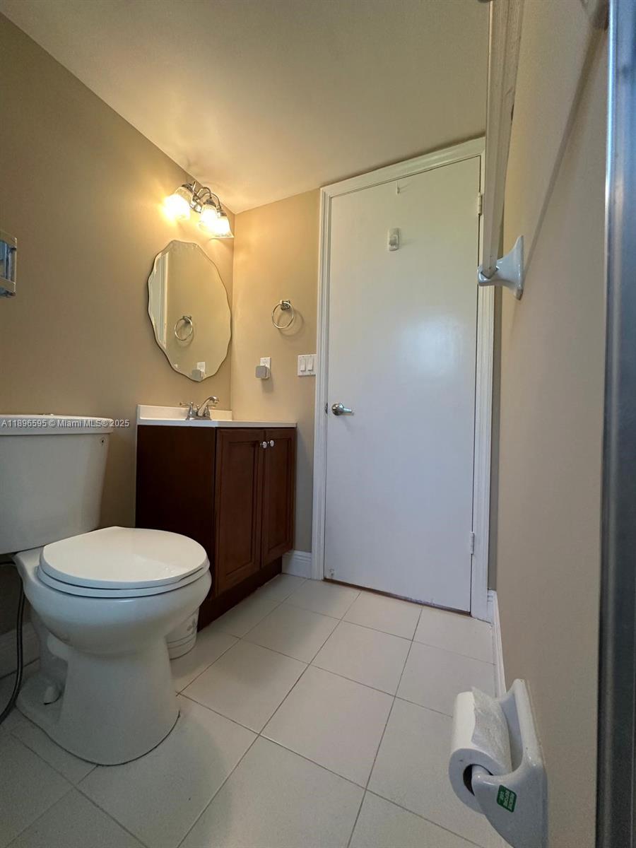 9848 Marina Boulevard, Unit 811 Boca Raton, FL 33428 - Photo 47 of 87 a bathroom with a toilet a sink and mirror