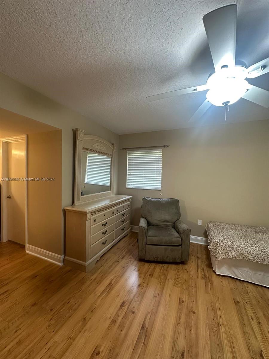 9848 Marina Boulevard, Unit 811 Boca Raton, FL 33428 - Photo 53 of 87 a living room with furniture and a wooden floor
