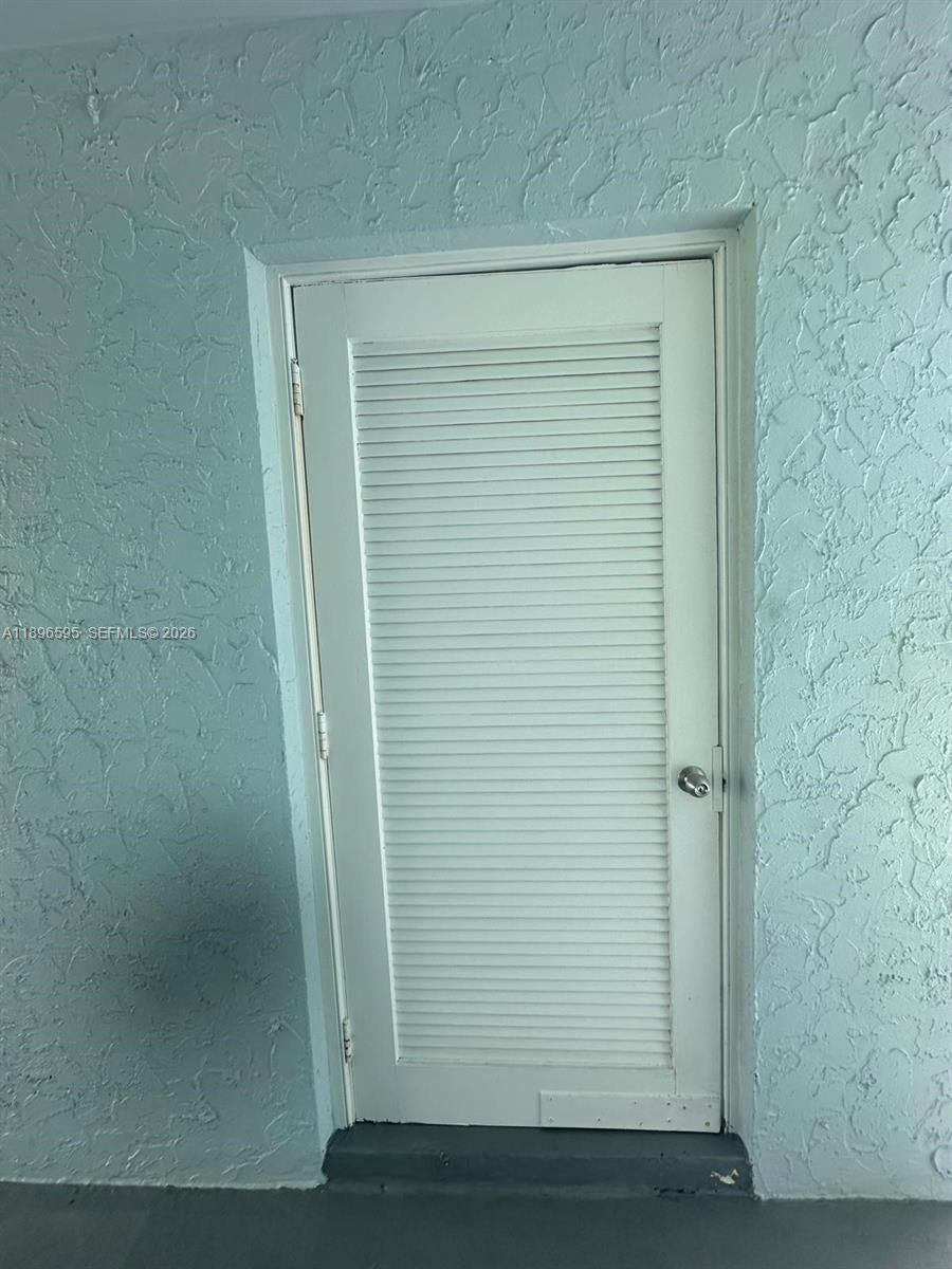 9848 Marina Boulevard, Unit 811 Boca Raton, FL 33428 - Photo 73 of 86 Laundry room door in the first floor