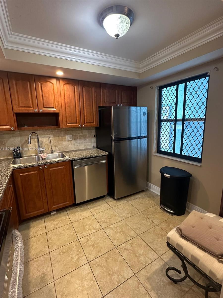 9848 Marina Boulevard, Unit 811 Boca Raton, FL 33428 - Photo 8 of 87 a kitchen with stainless steel appliances granite countertop a refrigerator a sink a stove top oven and a dishwasher