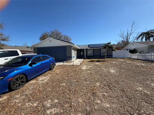 a front view of a house with cars
