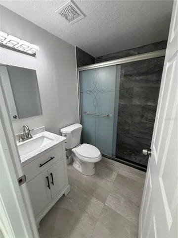a bathroom with a sink a toilet and mirror