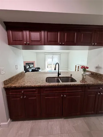a kitchen with a sink and cabinets