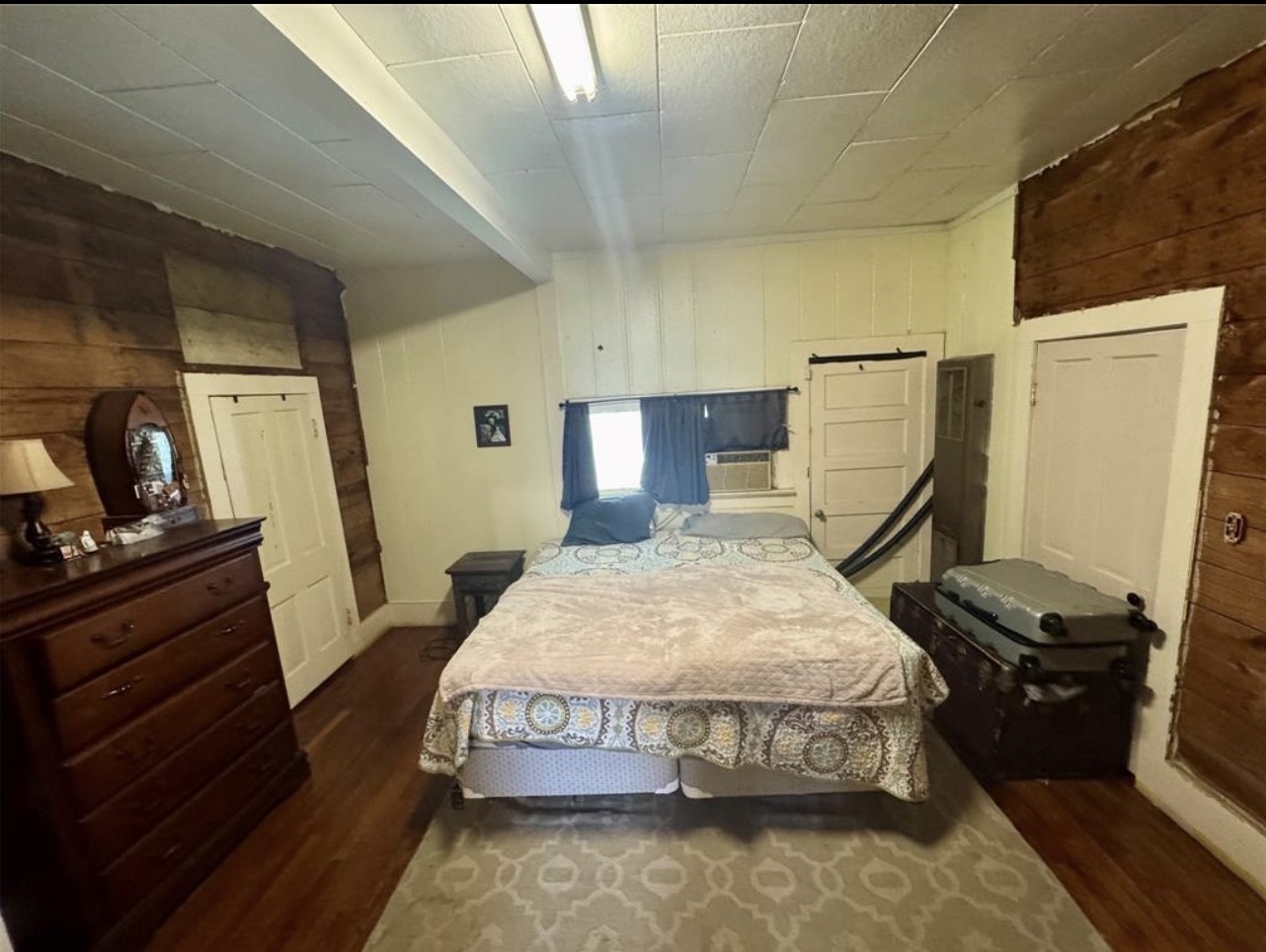 188 Elm Street Blessing, TX 77419 - Photo 13 of 19 a bedroom with a bed and wooden floor