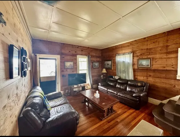 a living room with furniture fireplace and flat screen tv
