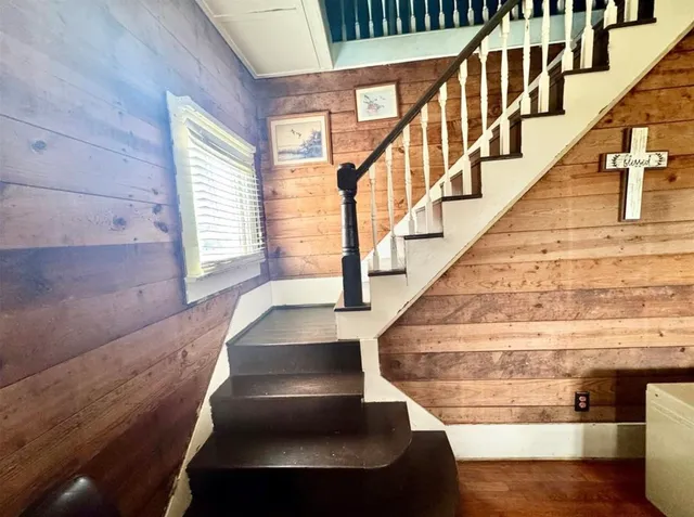 a view of entryway and hall with wooden floor