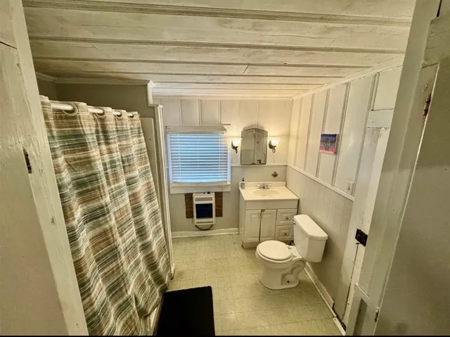 a bathroom with a toilet and a shower