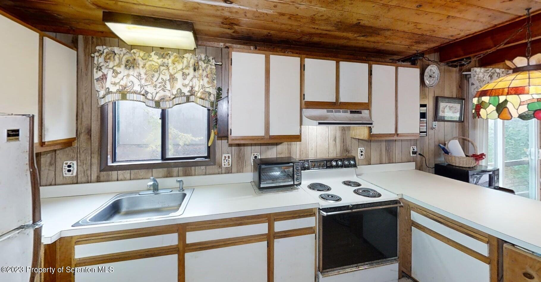 1144 Commanche Circle Lake Ariel, PA 18436 - Photo 17 of 28 a kitchen with a sink and a refrigerator