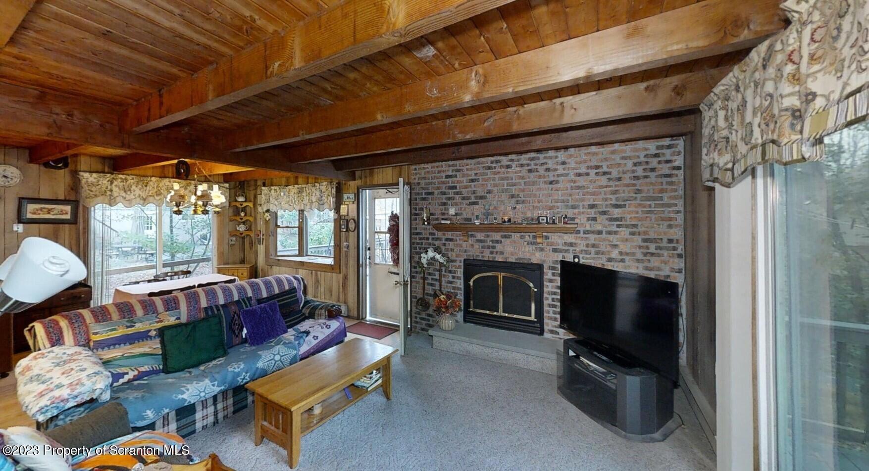 1144 Commanche Circle Lake Ariel, PA 18436 - Photo 20 of 28 a living room with furniture a fireplace and a table