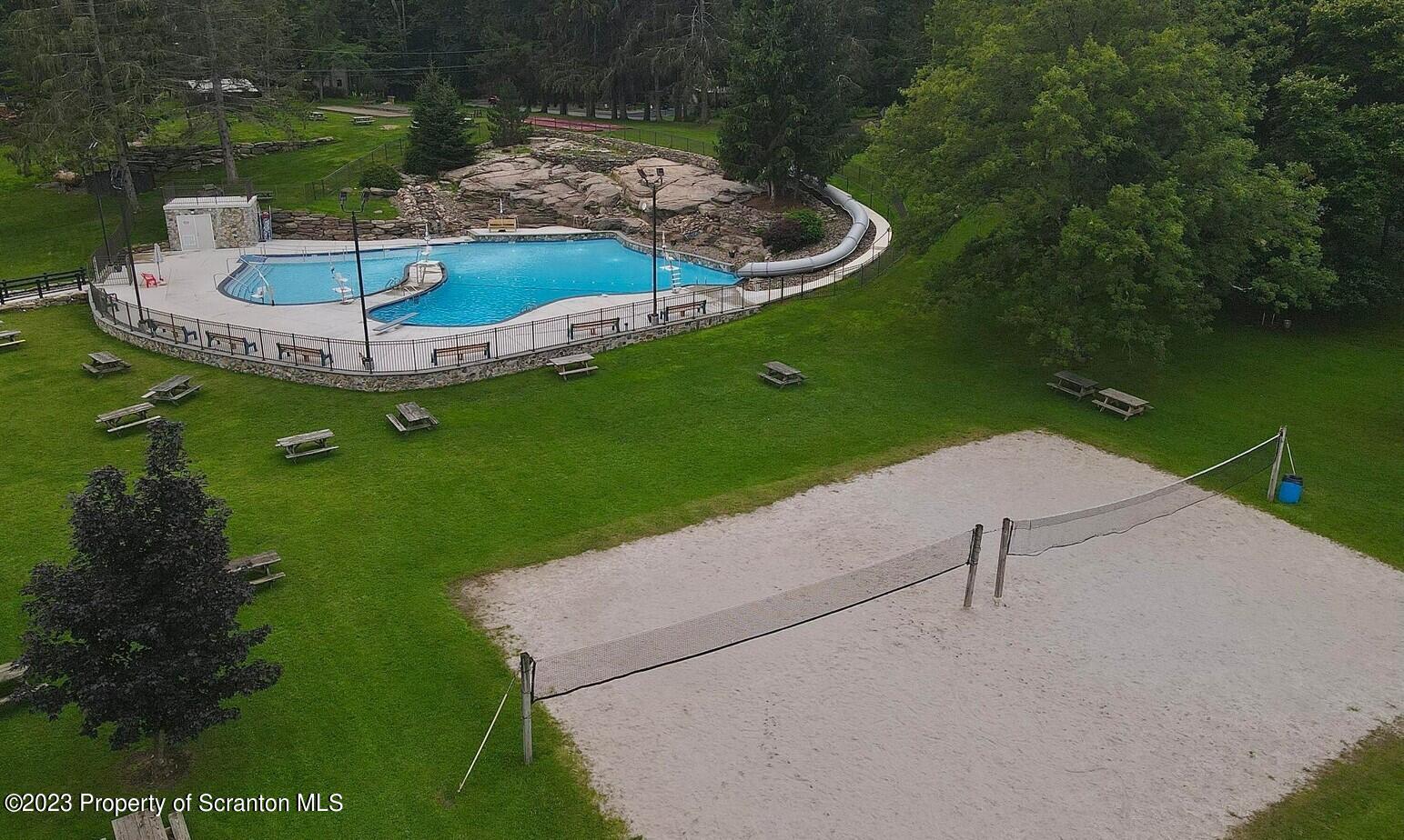 1144 Commanche Circle Lake Ariel, PA 18436 - Photo 28 of 28 a swimming pool with some trees in the background