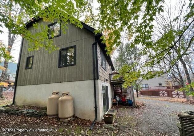 1144 Commanche Circle Lake Ariel, PA 18436 - Photo 4 of 28 a view of a small house with a tree and wooden fence