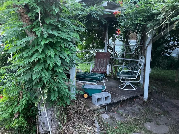 a view of a chairs and table in a backyard