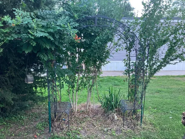 a view of a chairs setting in the deck in front of house