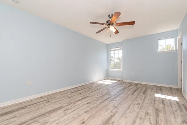 wooden floor in an empty room with a window