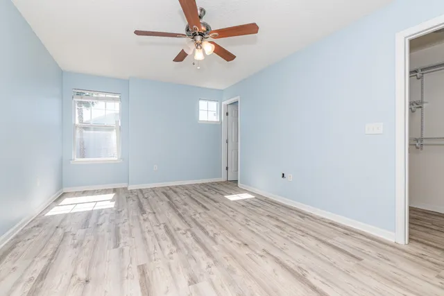 wooden floor in an empty room with a window