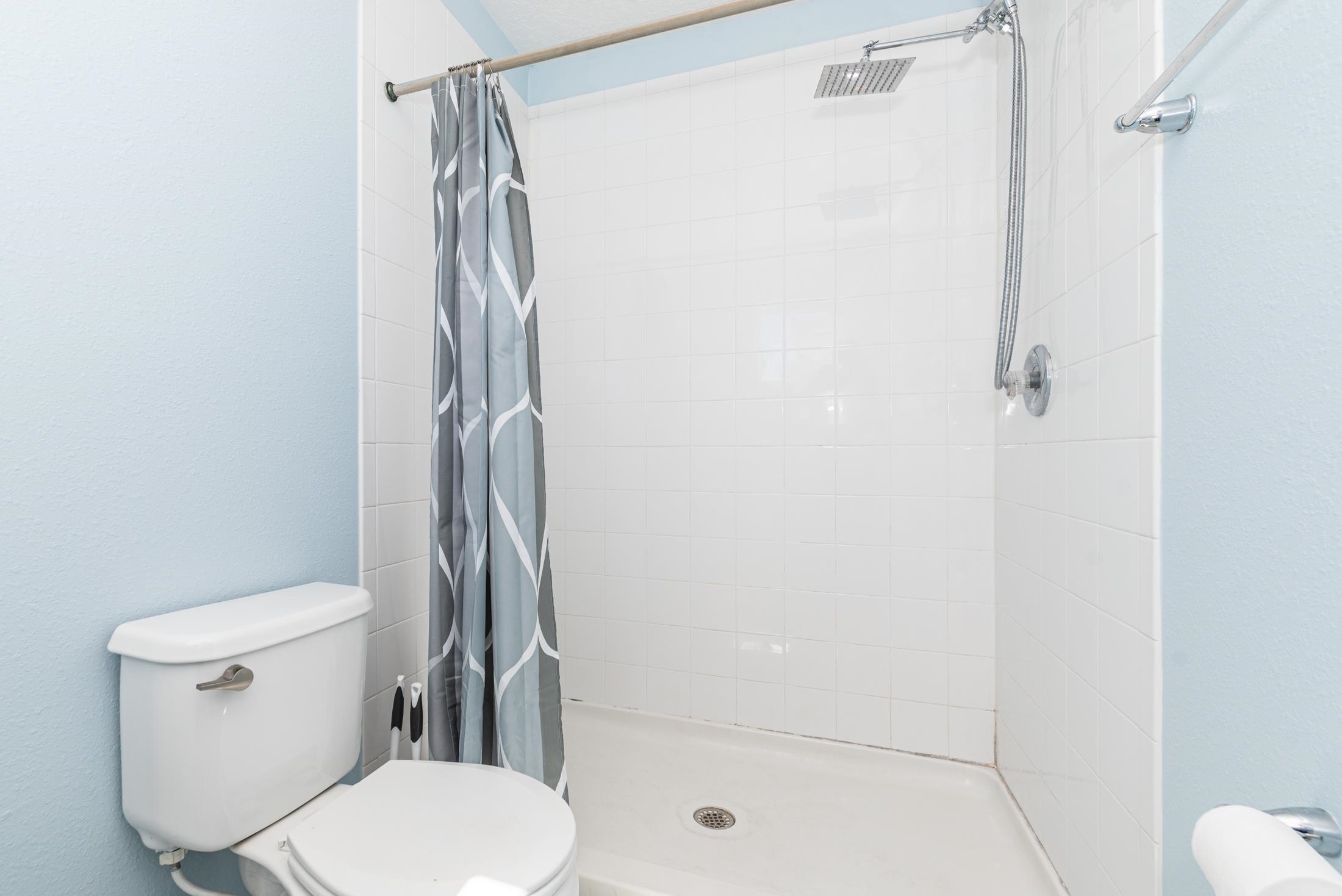 128 A Islander Circle St. Augustine, FL 32080 - Photo 15 of 26 a white toilet sitting next to a shower