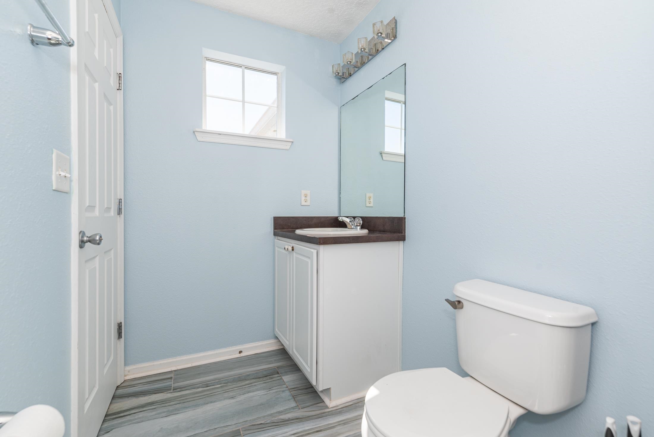 128 A Islander Circle St. Augustine, FL 32080 - Photo 16 of 26 a white toilet sitting next to a bathroom sink