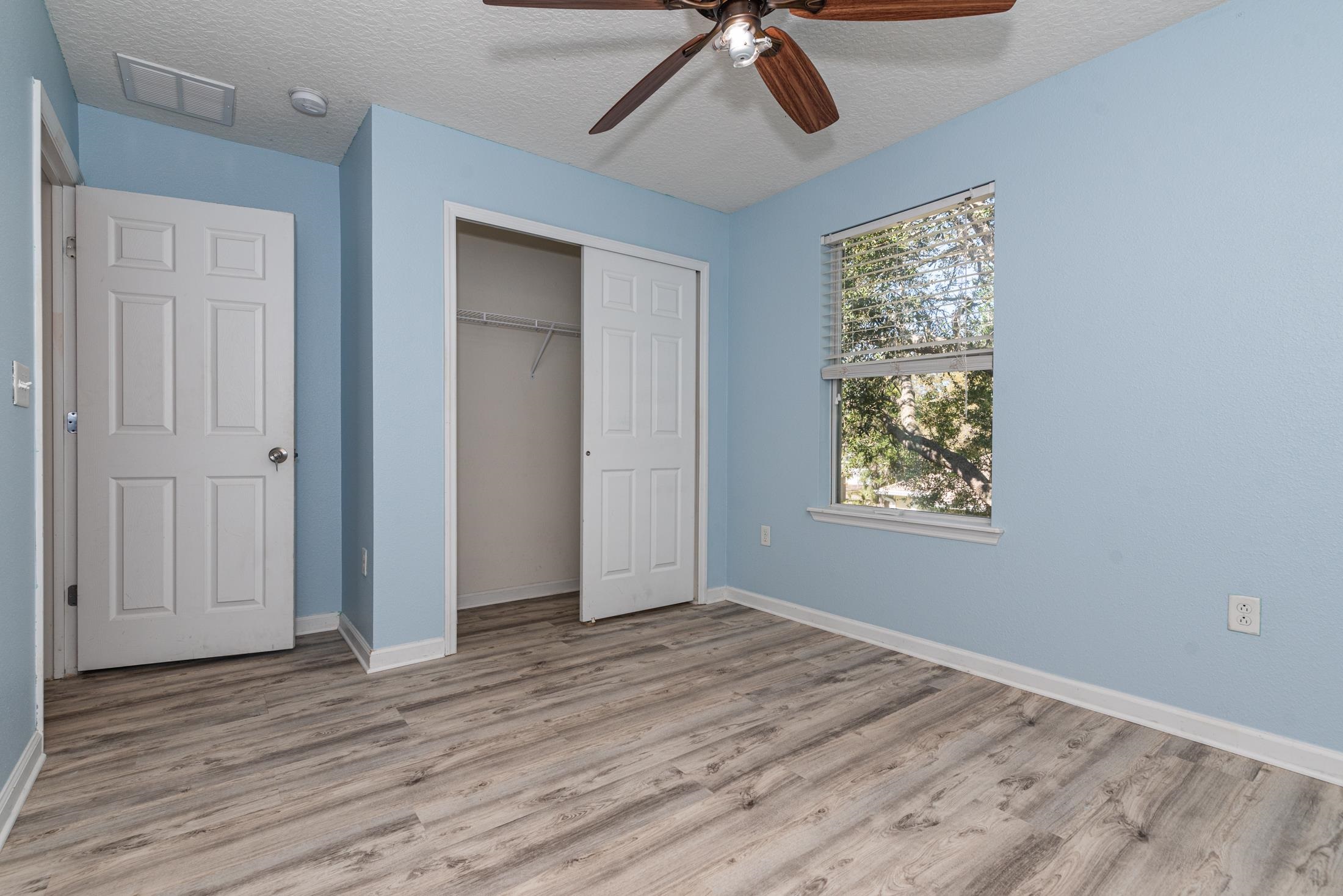 128 A Islander Circle St. Augustine, FL 32080 - Photo 19 of 26 a view of empty room with wooden floor and fan
