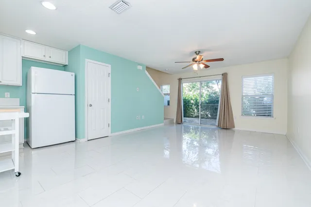 a view of a livingroom with a ceiling fan and window