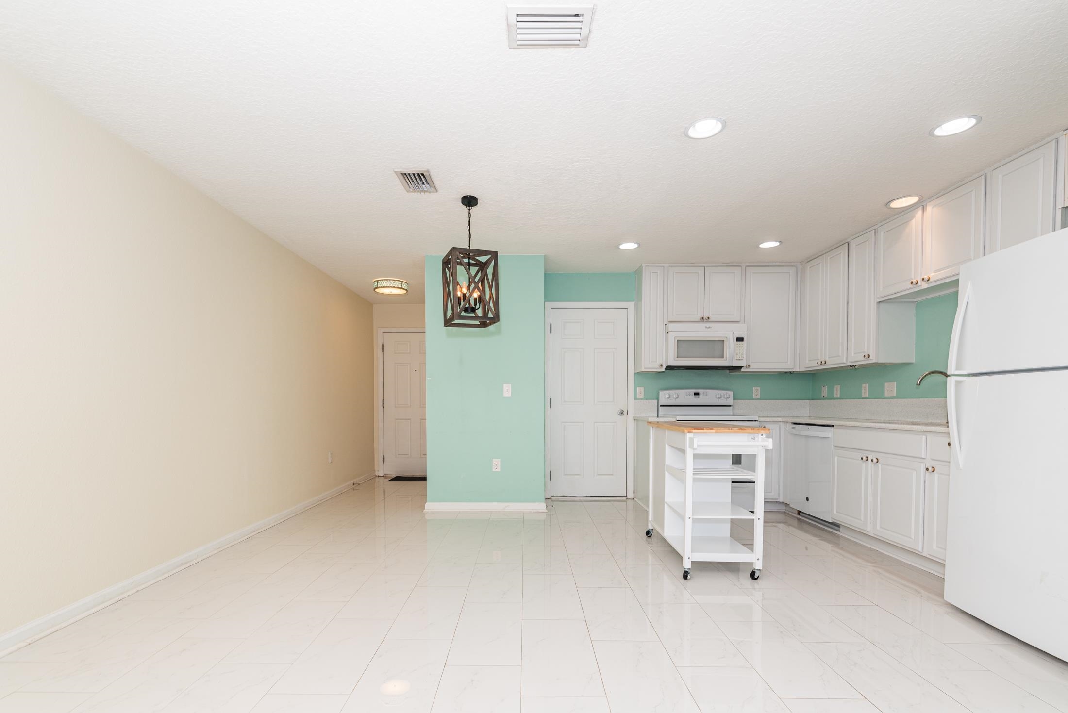 128 A Islander Circle St. Augustine, FL 32080 - Photo 6 of 26 a open kitchen with stainless steel appliances granite countertop a refrigerator and a stove top oven