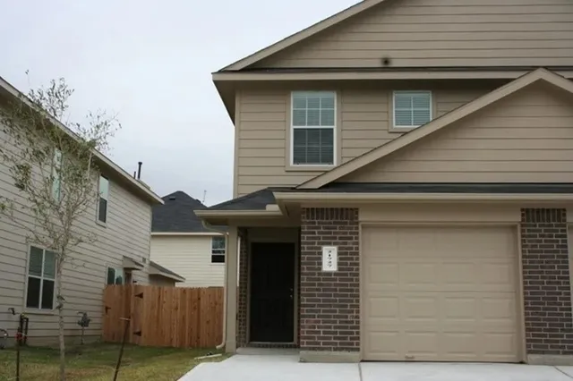 a front view of a house with garage