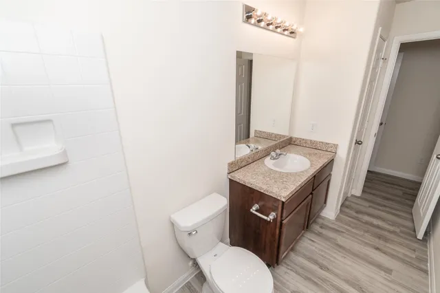 a bathroom with a toilet a sink and a mirror