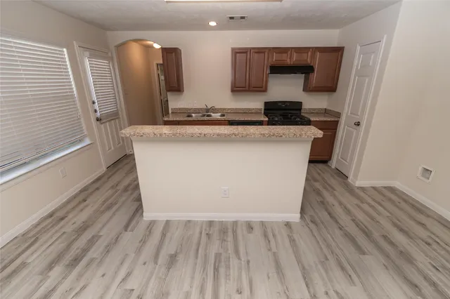 a room with a sink and wooden floor