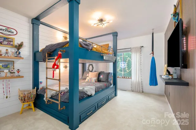 a bedroom with natural light and flat screen tv