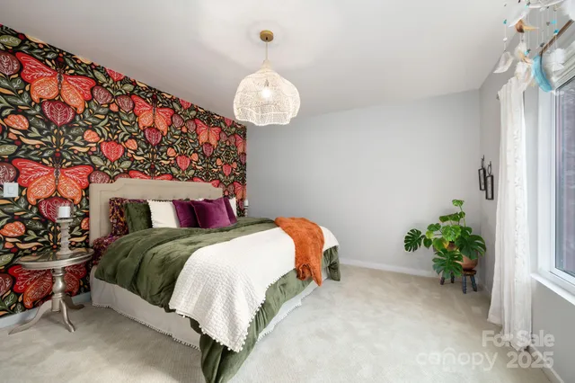 a bedroom with bed and a chandelier