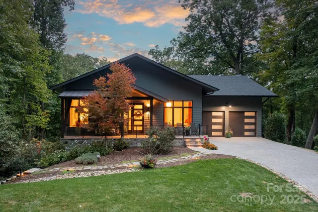 a front view of a house with swing and plants